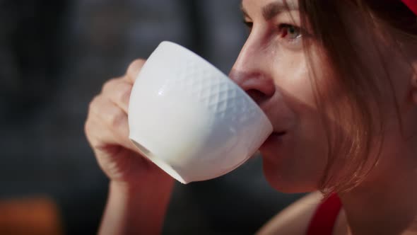 Happy Girl in a Cafe Drinks Coffee Enjoyment in the Summer and Lifestyle