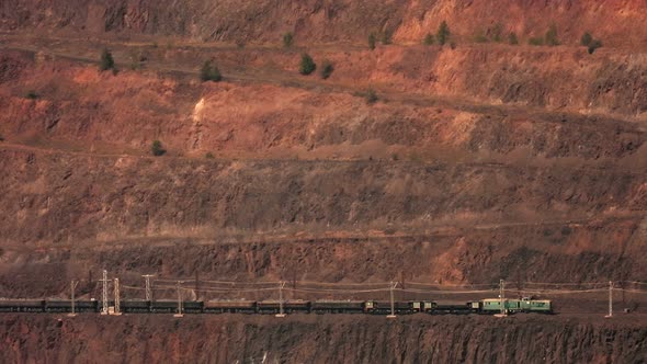 Panoramic view of the working process in an open-pit iron ore quarry.