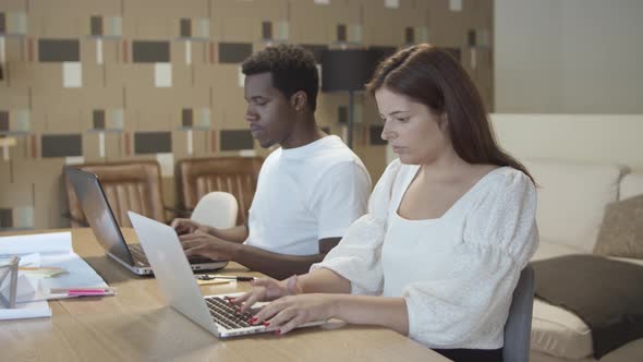 Two Coworkers Sitting Together at Table