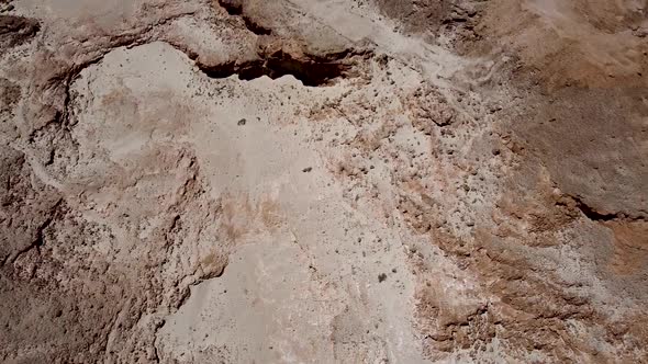 Aerial slow and calming forward drone shot of an empty desert full of different shades and colors, m