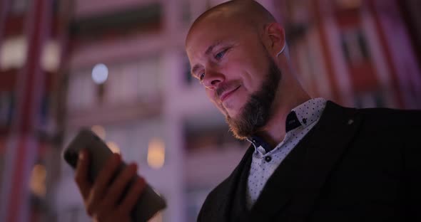 Businessman Using Smartphone at the Night City