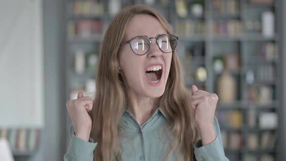 Portrait of Successful Woman Celebrating with Both Fist