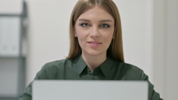 Portrait of Thumbs Up By Woman with Laptop 