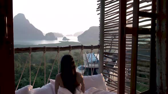 Phangnga Bay Asian Woman Waking Up in Bed in Nature Jungle Looking Out Over Ocean and Jungle During