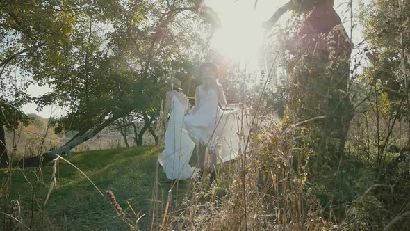 a couple of Young beautiful women in love in white wedding dresses are spinning and waving dresses o