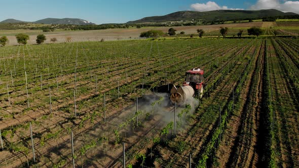 Chemicals used by agricultural tractor. Agricultural machinery works in the vineyards.