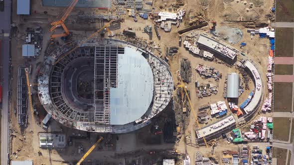 Half Roofed Sports Arena and Supplies at Construction Site