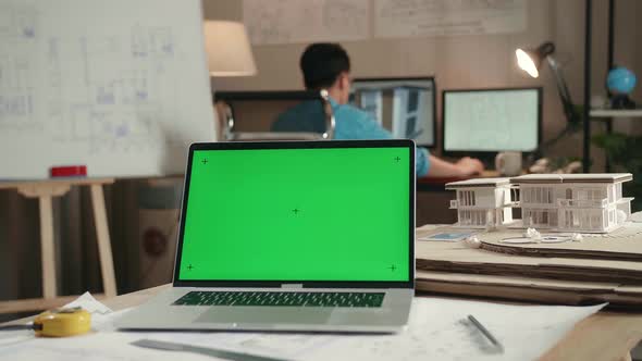 Green Screen Laptop In Front Of A Man Engineer Working With Desktop At The Architectural Office