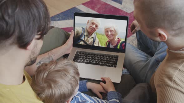 Fathers and Son Talking on Video Call with Grandparents