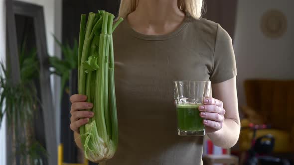 woman with celery juice in a glass at home