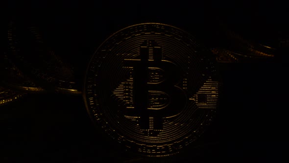 Bitcoin Gold Coins Shine and Shimmer in the Twinkling Light Strobe Effect. Close Up