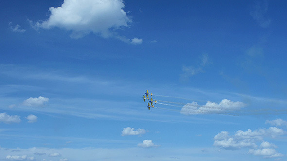 Airplanes Doing Tricks on Blue Sky Background 2