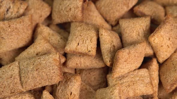 Crispy chocolate pads falling down macro. Cocoa cereal dessert for a fast breakfast. Morning