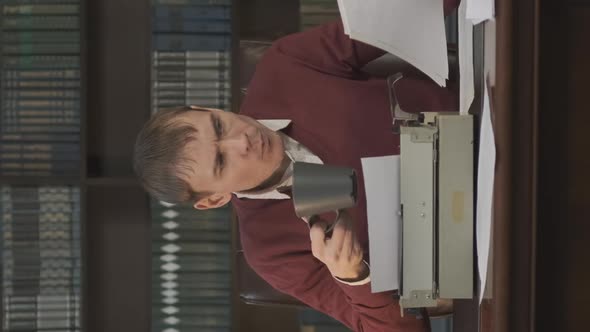 Focused Man Writing Article or Novel Indoors