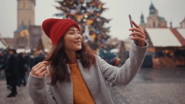 Young Girl with a Phone Do a Selfie