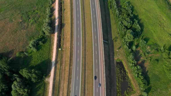 Aerial Vertical Shot. Cars Driving By the Road. Traffic on the Highway.  Footage From Drone. alt