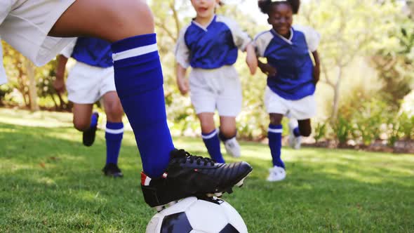 Kids playing a football in park