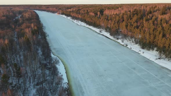 Spectacular Winter Landscape with Frozen River at Sunset Aerial View