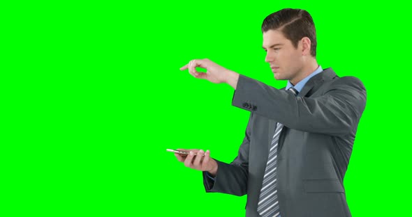 Young businessman gesturing while using mobile phone
