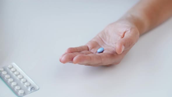 Woman Hands Opening Pack of Medicine Pills