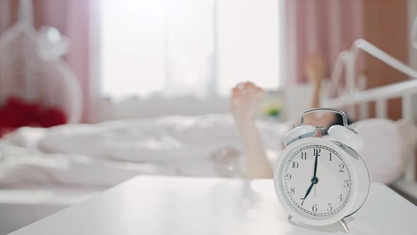 Woman Wakes Up and Stretches at the Morning