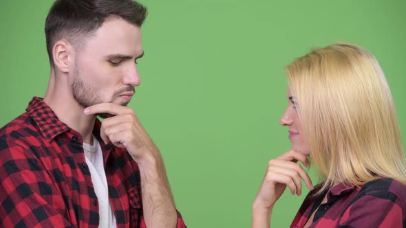 Young Couple Thinking While Looking at Each Other