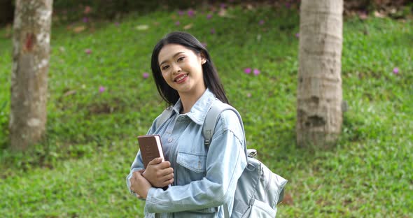 Asian Woman Student Hold Book And Pose