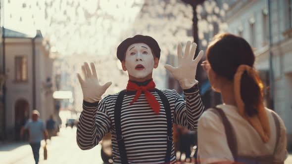 Young mime with young girl
