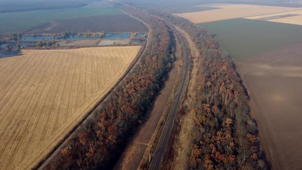 Panoramic Landscape View of Railway Trees Agricultural Fields Lakes on Sunny