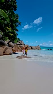 Anse Georgette Praslin Seychelles Young Couple Men and Woman on a Tropical Beach During a Luxury