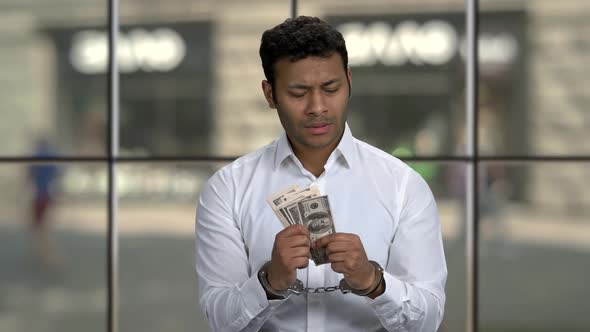 Handcuffed Businessman Holding Money