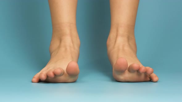 Close up of bare child feet on blue background.