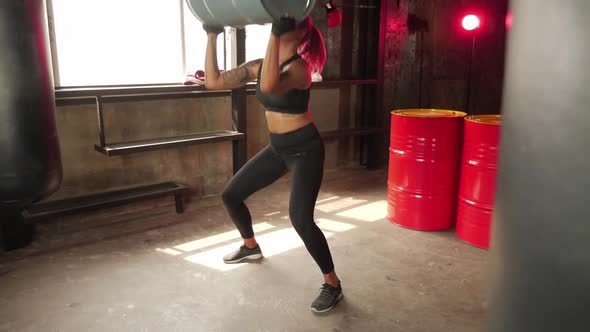 Sporty woman exercising building muscles at the gym