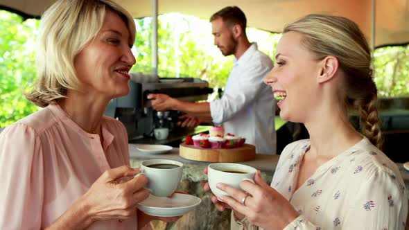 Happy friends enjoying coffee together 4k