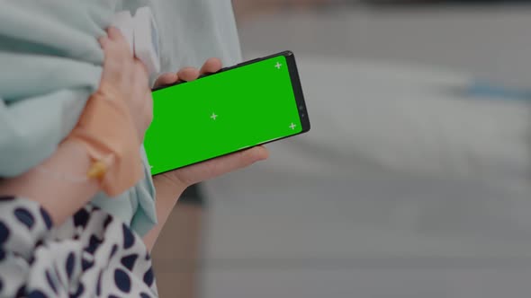 Vertical Video Little Kid Holding Mock Up Green Screen Chroma Key Phone with Isolated Display