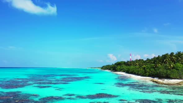 Aerial flying over landscape of perfect lagoon beach adventure by blue water with white sandy backgr