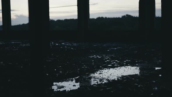 A Pool of Rainwater During the Rain on the Ruins of the Building.