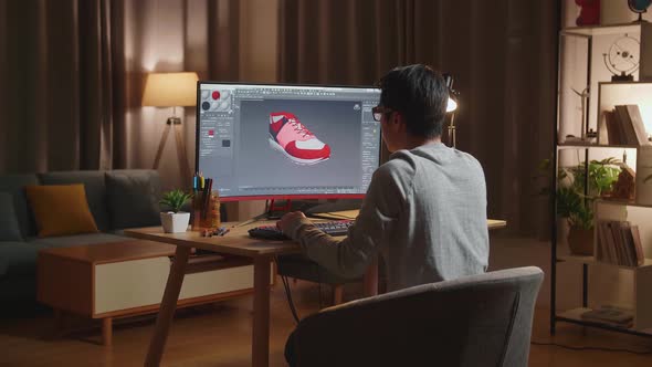 Male Footwear Designer Rotate 3D Model Of Shoe And Change Colours On It While Working On A Desktop