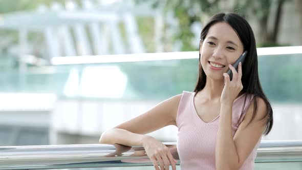 Woman use of mobile phone in city 