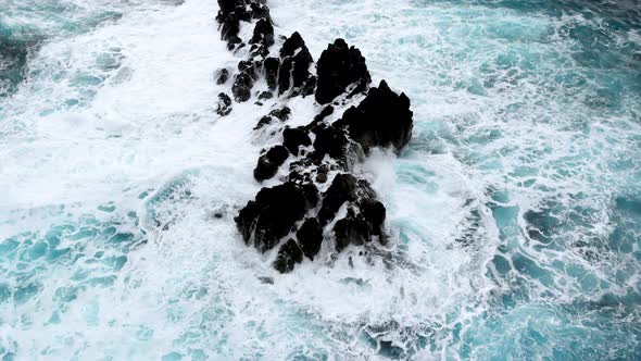 Top Down View of Big Waves Crashing Into Cliffs Near the Shores of Madeira Island Portugal