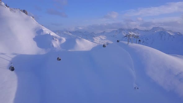 Aerial drone view of a ski gondola lift and mountains at a ski resort