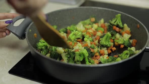 Mixing Fresh Vegetables on Frying Pan. Boiling Carrots, Cauliflower, Broccoli
