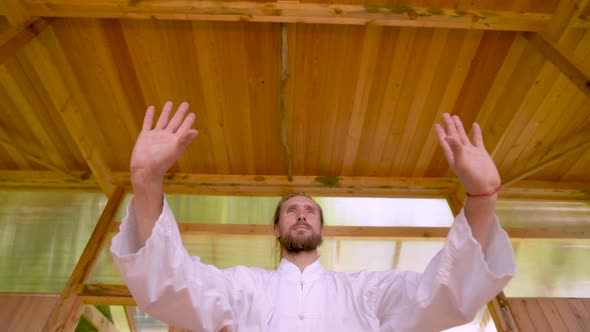 Closeup Bearded Caucasian Man Wearing White Clothes To Practice Concentration and Breathing Before