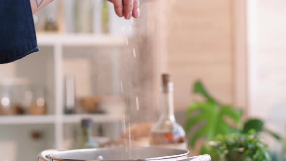 Adding Salt to Boiling Water in Pot