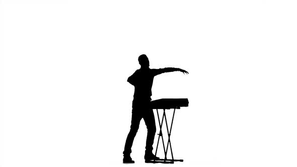 Piano Playing. Man in Half-turn. Silhouette. Slow Motion