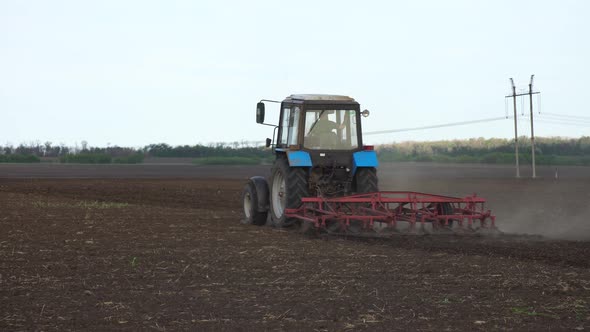 Tractor plows the farm field