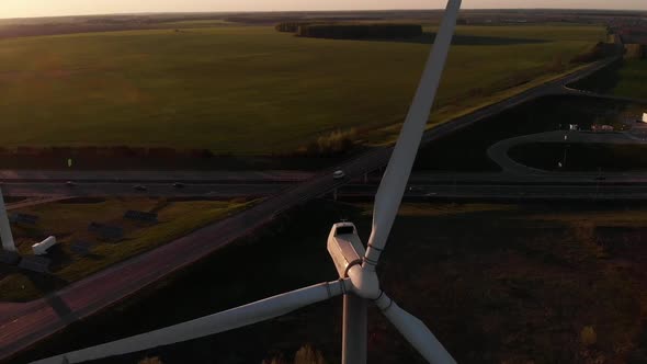 Drone Shooting Closeup of the Rotating Blades of a Windmill Against the Backdrop of Green Meadows