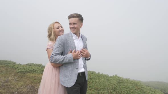 Elegant couple walking on a hill