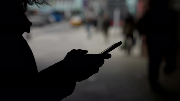 Anonymous User of Social Nets Dark Silhouette of Person with Smartphone in Hands Sending Message