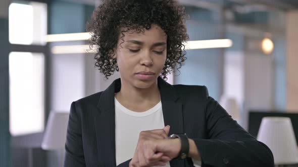 Portrait of Focused African Businesswoman Using Smart Watch